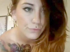 Breathtaking brunette with tatts and big tits rubs her cunt