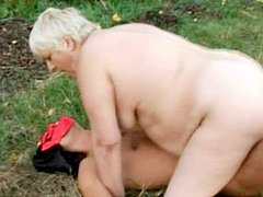 Fat granny is sucking big dick outdoors
