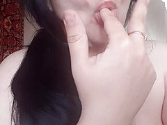 Sexy girl sucking fingers and imagining a huge cock in mouth