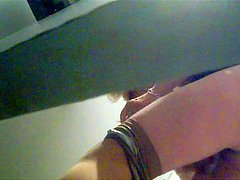 Unknown babe is pissing in the public toilet