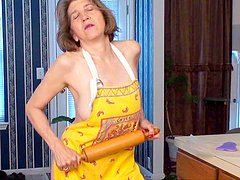 Mature milf Bobby Bentley pokes her snatch with a wooden stick