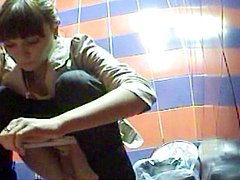 Perverted brunette is poking her pussy during pissing