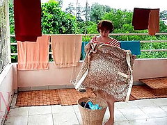 Naked laundry. The maid is drying clothes in the laundry.