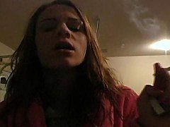 Teenager in bathrobe smokes sensually